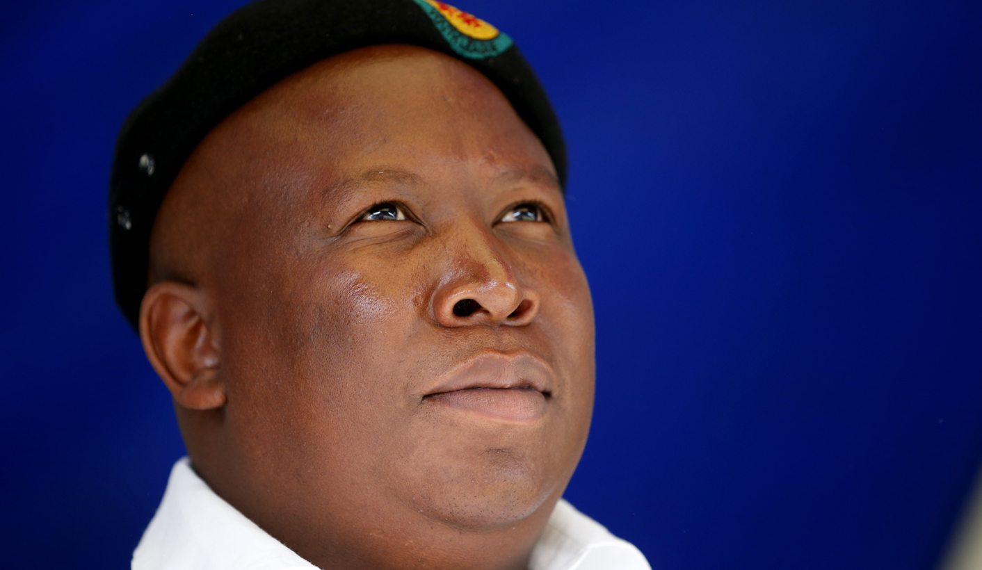 Expelled African National Congress Youth League leader Malema looks on as he addresses mineworkers in the small mining town of Virginia