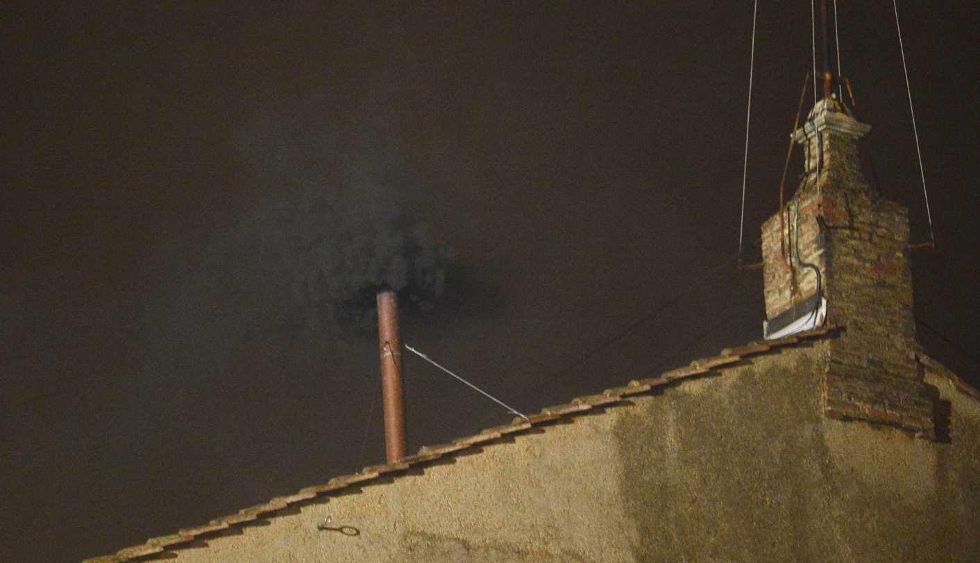 Black smoke rises from the chimney on the roof of the Sistine Chapel in the Vatican City