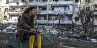 epa09826875 A woman stands by the debris of a building damaged by shelling in Kyiv, Ukraine, 15 March 2022. On 24 February Russian troops had entered Ukrainian territory in what the Russian president declared a 'special military operation', resulting in fighting and destruction in the country, a huge flow of refugees, and multiple sanctions against Russia.  EPA-EFE/MIGUEL A. LOPES
