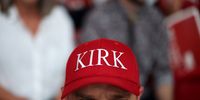 An attendee wearing a red 'Kirk' hat sits in the stands ahead of the memorial service for political activist Charlie Kirk at State Farm Stadium on September 21, 2025 in Glendale, Arizona. Kirk, the CEO and co-founder of Turning Point USA, was shot and killed on September 10th while speaking at an event during his "American Comeback Tour" at Utah Valley University. (Photo by Eric Thayer/Getty Images)