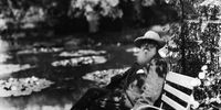 French impressionist painter Claude Monet (1840 - 1926) sits on a bench beside the water lily pond in his home garden, Giverny, France, 1910s.(Photo by Hulton Archive/Getty Images)