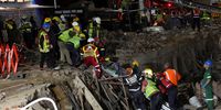 Rescuers carry a person on a stretcher as they race to save construction workers trapped under a building that collapsed in George. (Photo: Reuters / Esa Alexander)