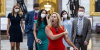 epa09380540 Republican Representative from Georgia Marjorie Taylor Greene removes her mask dramatically while crossing from the House side of the US Capitol (where masks are required) to the Senate side (where they are not) in Washington, DC, USA, 30 July 2021. On 27 July, Brian Monahan, the Capitol's attending physician, reimposed a mask mandate for House lawmakers and congressional staff.  EPA-EFE/JIM LO SCALZO
