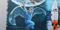 A mural to honor the medics currently helping to fight COVID-19 is seen on April 22, 2020 in Melbourne, Australia. All non-essential business are closed and strict social distancing rules are in place in response to the COVID-19 pandemic, while public gatherings are limited to two people. New South Wales and Victoria have enacted additional lockdown measures to allow police the power to fine people who breach the two-person outdoor gathering limit or leave their homes without a reasonable excuse. Queensland, Western Australia, South Australia, Tasmania and the Northern Territory have all closed their borders to non-essential travellers and international arrivals into Australia are being sent to mandatory quarantine in hotels for 14 days. (Photo by Robert Cianflone/Getty Images)