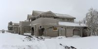 Homes are covered with ice after being battered with waves from Lake Erie along Hoover Beach on December 27, 2022 in Hamburg, New York. The historic winter storm Elliott dumped up to four feet of snow, leaving thousands without power and at least 28 confirmed dead in the city of Buffalo and the surrounding suburbs. (Photo by John Normile/Getty Images)