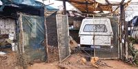 A chained dog barks at South African Defence and Police forces while on a sting operation, Zamimpilo Informal Settlement, Johannesburg, South Africa, 14 April 2020