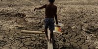 Fisherman and trader Raimundo Silva do Carmo, 67, goes out to fetch water from a well he had dug himself in a dry area of Lago do Puraquequara lake, in Manaus, Amazonas, Brazil, 06 October 2023 (issued 07 October 2023). Drought is severely hitting the Brazilian Amazon, where some inhabitants have been forced to dig handmade wells with a handful of boards on dry lake beds in search of water in order to survive.  EPA-EFE/Raphael Alves