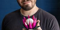 Designer Christoff van Wyk with a Lego protea flower he created (Photo: Supplied)