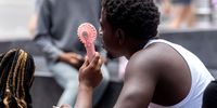 Visitors use a handheld fan during a heat wave in New York, US, on Thursday, July 27, 2023. New York City and the Northeast are in for their hottest day of the year as oppressive temperatures descend on the eastern and central US, affecting about half the country's population. (Photo: Jeenah Moon/Bloomberg via Getty Images)