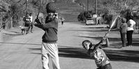 Calvinia, Northern Cape: Steven Charles teaching the youngsters of Calvinia West to play golf on the speed humps with donated clubs and balls. In many small towns, Rastafarians help to educate children, rehabilitate criminals, and protect women.<br>