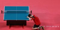 TOKYO, JAPAN - JULY 30: Dimitrij Ovtcharov of Team Germany kneels the table after winning his Men's Singles Bronze Medal match on day seven of the Tokyo 2020 Olympic Games at Tokyo Metropolitan Gymnasium on July 30, 2021 in Tokyo, Japan. (Photo by Justin Setterfield/Getty Images)