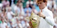 Jannik Sinner of Italy celebrates with the trophy after winning the Men's Singles final match against Carlos Alcaraz of Spain at the Wimbledon Championships, Wimbledon, Britain, 13 July 2025.  EPA/NEIL HALL  EDITORIAL USE ONLY