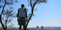<br>Caption: Raymond 'McBirdie' Rampolokeng from Bay of Grace Tours,Soweto's only bird guide atop Enoch Sontonga Hills overlooking the iconic Soweto Towers in Orlando East
