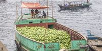 Bangladeshi vendors sit on the boat as they anchor their boat at the Buriganga River in Dhaka, Bangladesh, 16 March 2023.  Watermelon is at harvesting season and is filling the city markets as it arrives from southern Bangladesh.  EPA-EFE/MONIRUL ALAM