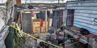 A South African woman sits in her yard in the 7de Laan shack settlement, Strandfontein, Cape Town, South Africa, 20 April 2020. (Photo: EPA-EFE/NIC BOTHMA)