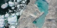 In this aerial view melting ice forms a lake on free-floating ice jammed into the Ilulissat Icefjord during unseasonably warm weather on July 30, 2019 near Ilulissat, Greenland. The Sahara heat wave that recently sent temperatures to record levels in parts of Europe is arriving in Greenland. Climate change is having a profound effect in Greenland, where over the last several decades summers have become longer and the rate that glaciers and the Greenland ice cap are retreating has accelerated.   (Photo by Sean Gallup/Getty Images)