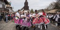Dressed in folk costumes, young women perform a traditional dance in Holloko, a mountain village enlisted on the World Heritage List of Unesco, some 80 kms northeast of Budapest, Hungary, 10 April 2023. According to an old Hungarian tradition, on Easter Monday young men pour water on young women, who in exchange present their sprinklers with hand-decorated coloured eggs.  EPA-EFE/Peter Komka HUNGARY OUT