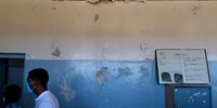 Peeling paint and water damage is visible on the prison’s interior walls. (Photo: Daniel Steyn)