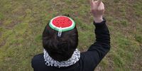 A protester wearing a watermelon yarmulke, which is a solidarity with Palestine symbol, makes a peace sign as police clear a pro-Palestine protest camp near the Chancellery on April 26, 2024 in Berlin, Germany. Several dozen protesters, who were demanding an end to Israeli bombing in Gaza, have been camping at the site over the past several weeks. (Photo by Sean Gallup/Getty Images)