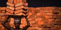 An Indian laborer carries bricks on his head at an under-construction commercial complex, in Chennai, India, 05 July 2023.  EPA-EFE/IDREES MOHAMMED