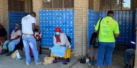 Fieldworkers from the community speaking to pensioners about the health screening outside the SA Post Office where they collect their social grant.(Photo: Jane Simmonds/SAMRC/Wits)