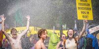 A placard that reads 'which fossils still invest in oil?' as the police use water cannons against Extinction Rebellion activists who are blocking the A12, in The Hague, the Netherlands, 27 May 2023. With the action, Extinction Rebellion wants to make the Dutch government know it opposes fossil subsidies. During the most recent blockade on 11 March some 700 activists were arrested.  EPA-EFE/Sem van der Wal