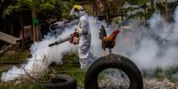 MANILA, PHILIPPINES - MARCH 26: A worker wearing a hazmat suit uses a fogging machine to disinfect a slum community along a railway as preventive measure against COVID-19 on March 26, 2021 in Manila, Philippines. Curfews and stricter lockdowns are being implemented in several areas across the Philippines as the country experiences its worst surge in cases since the lockdown began more than a year ago. The country has reported more than 693,000 cases of COVID-19 so far, with at least 13,095 deaths. (Photo by Ezra Acayan/Getty Images)