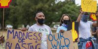 Environmental activists protest against Shell outside the Petroleum Agency of South Africa in Cape Town, on 26 November 2021. Environmentalists across the country are outraged over Shell’s planned survey off South Africa’s pristine Wild Coast. (Photo: EPA-EFE / Nic Bothma)