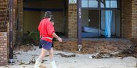 A resident takes a video of one of the houses that was damaged on Beach road above Bikini beach. 17 September 2023. (Photo: Shelley Christians)