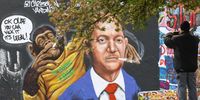 A man takes a picture of a mural by Berlin-based graffiti artist Eme Freethinker depicting a chimpanzee handing a joint to German Chancellor Olaf Scholz and reading "Ok Olaf you can kick it it's legal!", in Berlin, Germany, 03 April 2024. The German Federal Council 'Bundesrat' on 22 March approved a law decriminalizing the recreational usage of cannabis in Germany for adults aged 18 and over. Starting 01 April 2024 it will be legal for adults in Germany to possess up to 50 grams of dried cannabis at home and up to 25 grams in public for personal use. The law allows growth and distribution only in cultivation associations also called Cannabis Social Clubs and comes into force on 01 July 2024. People can purchase cannabis for recreational use if they are members of those specific clubs but cannot consume it on the premises.  EPA-EFE/HANNIBAL HANSCHKE