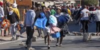 Looting in Ndofaya on July 12, 2021 in Soweto, South Africa. It is reported that the sporadic protests started in KwaZulu-Natal last week with Zuma's supporters calling for his immediate release and have now spread to some parts of the country.   (Photo by Gallo Images/Papi Morake)