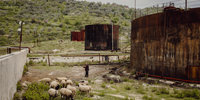 Arben Cela, a retired worker from the local refinery, tends his sheep at the Alpetrol oil treatment facility near Ballsh. The smell of gas and oil is always present. Albania is one of the poorest European countries, with a per capita income of US$4,500. Yet it has a subsoil that is rich in crude oil, with more than 5.3 billion barrels lying beneath the surface. During the communist dictatorship of Enver Hoxha, the country was isolated, leaving it open only to Soviet and Chinese influences. These relationships led to the development of the technological capabilities necessary to begin tapping into Albania’s oil wells, but since the fall of the regime, free market capitalism has taken hold. Now, various corporations, including Bankers Petroleum, a Canadian company recently acquired by China’s Geo-Jade Petroleum, own 95 percent of crude oil extraction in the Patos-Marzina region. This seismic shift in the market has caused significant social and environmental issues, including contaminated lakes, oil leaks, abandoned structures, the poisoning of underground water wells and emissions that affect the surrounding villages. Image: © Jonas Kakó, Germany, Shortlist, Professional competition, Environment, Sony World Photography Awards 2024