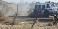 Police fire live ammunition at mine workers on August 16, 2012 at the koppie. (Photo :Felix Dlangamandla)