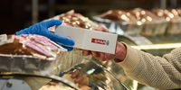 A worker hands a branded bakery item box to a customer inside a Spar Group supermarket in the Die Wilgers suburb of Pretoria, South Africa, July 14, 2022. (Photo: Waldo Swiegers / Bloomberg via Getty Images)