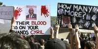 People gather during the gender-based violence demonstration outside Parliament, following the rape and murder of UCT student Uyinene Mrwetyana on 5 September, 2019 in Cape Town, South Africa. South African President Cyril Ramaphosa skipped the World Economic Forum to address thousands of Capetonians mostly all dressed in black, where he said laws were to be changed with regards to violence and rape against women. (Photo by Gallo Images/Brenton Geach)