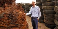 Dr Mehran Zarrebini, CEO of Mathe Group at the group‘s factory in Hammarsdale, KZN. On the left is the steel removed from old truck tyres and on the right are used tyres waiting to be recycled. (Photo: Supplied)