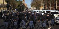 Members of the SAPS take instruction from their superior before heading out to secure the area surrounding the Pietermaritzburg High Court where the trial of ex President Jacob Zuma is set to take place. 19 July 2021.<br>Photo / Shiraaz Mohamed