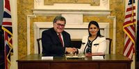 US Attorney General William Barr, left, and UK Home Secretary Priti Patel, right, sign the Cloud Act at a ceremony at the British Ambassador’s residence in Washington, DC, US, 3 October 2019. (Photo: US Department of Justice)