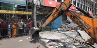 A bulldozer demolishes structures in Delhi’s violence-hit Jahangirpuri area in New Delhi on 20 April 2022. (Photo: EPA-EFE  / Rajat Gupta)