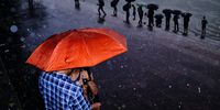 Monsoon in my city. "I took this picture in Kolkata, India. Whenever it rains, I love to use flash. I saw this couple having a moment away from the crowd in the heavy rain. I loved the orange umbrella, the colour stands out and in the background, people with umbrella creates an echo in the photograph. The internal flash was enough to create this dreamy effect in rain." © Subhran Karmakar, India, entry, Open Competition, Street Photography, 2023 Sony World Photography Awards