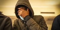 Accused Siphiwe Mazibuko covers his face as he stands in the dock of the Johannesburg Magistrates Court. <br>Photo / Shiraaz Mohamed.