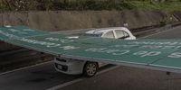A highway sign over a car in the aftermath of Hurricane Otis in Acapulco, Guerrero state, Mexico, on Thursday, Oct. 26, 2023. Hurricane Otis left a trail of destruction in Acapulco after tearing into the historic Mexican beach town with wind speeds of 165 miles (266 kilometers) per hour, smashing shops and wrecking apartment buildings and hotels. Photographer: Alejandro Cegarra/Bloomberg via Getty Images