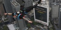 A BASE (Building, Antenna, Span and Earth) jumper in action above Kuala Lumpur skyline during the Kuala Lumpur BASE jump event in Kuala Lumpur, Malaysia 03 February 2023. More than 100 BASE jumpers took part in the extreme sport event.  EPA-EFE/FAZRY ISMAIL