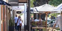 Restaurants and cafes spill onto the streets along the town's sidewalks, a concept that is in stark contrast to the congestion of peak traffic that regularly clogs the leafy single lane roads. <br>(Photo: Ashraf Hendricks)