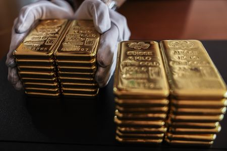 Gold holds four-day gain on haven demand and dovish Fed comments
