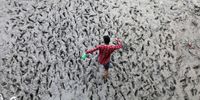 A Hindu devotee walks through mud to collect holy water after performing the 'Tarpan' ritual during Mahalaya prayers, known as Pitru Paksha in Kolkata, India, 14 October 2023. Bengalis worldwide will celebrate the festival from October 16 to 19, symbolizing the triumph of good over evil and honoring female power.  EPA-EFE/PIYAL ADHIKARY