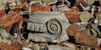 Part of one of the outside pillars lying in a pile of broken bricks. Image: Chris Marais