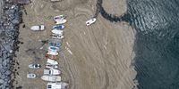 epaselect epa09247109 An aerial photo made with a drone shows fishing boats on the Marmara sea covered by sea snot in Istanbul, Turkey, 04 June 2021. Because of global heating, blanket of mucus-like substance in Marmara sea increasing day by day threatens fishing industry and the environment. Sea snot is formed as a result of the proliferation of microalgae called phytoplankton in the sea. The biggest reason for this is that the water temperature in the Marmara sea is 2.5 degrees above the average of the last 40 years.  EPA-EFE/ERDEM SAHIN