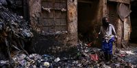 A man pries away rubbish with the use of a pick axe.<br>(Photo: Shiraaz Mohamed)