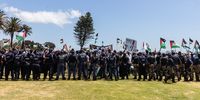 Police separate a large group of pro-Palestinian supporters from a small group of pro-Israel supporters. (Photo: Ashraf Hendricks) 